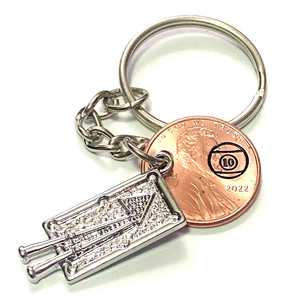 A silver pool table charm Billiards Pro Lucky Penny Keychain with a hand stamped 10 Ball.