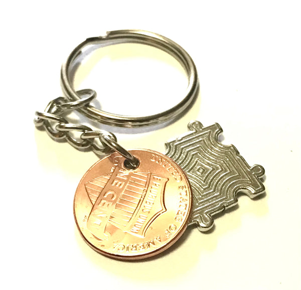 Autism Awareness Puzzle Piece Charm Lucky Penny Keychain with Smiley Face engraving above the date on a Lincoln Cent.