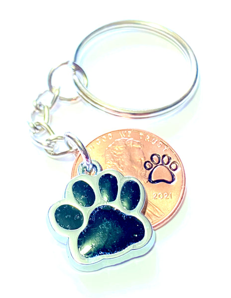 Black Glitter Dog Paw Print Charm Lucky Penny Keychain with an engraved paw print design above the date of a Lincoln Cent.