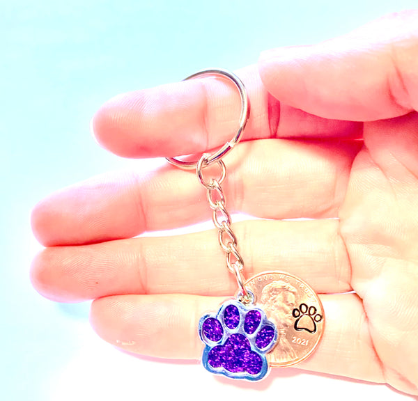 Purple Dog Paw Print Charm Lucky Penny Keychain with an engraved dog paw design above the date of a Lincoln Cent.