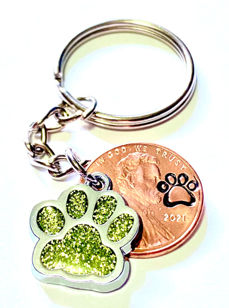 Yellow Glitter Dog Paw Print Charm Lucky Penny Keychain with an engraved paw print design above the date of a Lincoln Cent.
