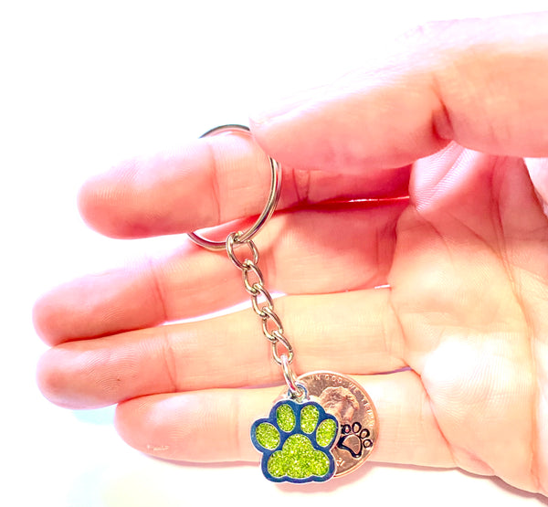 Yellow Dog Paw Print Charm Lucky Penny Keychain with an engraved dog paw design above the date of a Lincoln Cent.