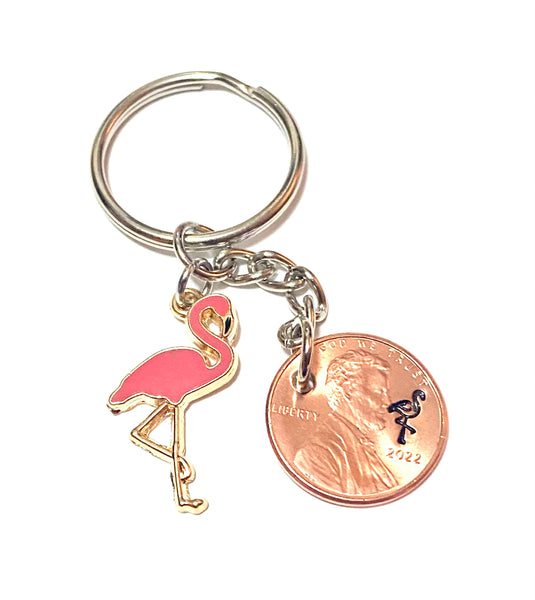 A Pink Flamingo keychain with a stamped flamingo bird above the date of a Lincoln Cent with a Pink Flamingo charm on this Lucky Penny Keychain.