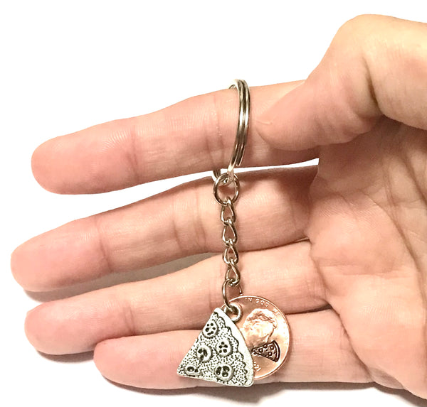 A Pizza Slice Silver Charm Lucky Penny Keychain with engraving of pizza slice above the date of a Lincoln Cent.