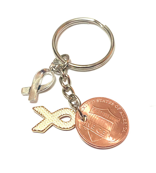 A red ribbon awareness charm on a 3" keychain with a silver HOPE charm attached to a Lincoln Cent with a detailed design of an awareness ribbon above the date to make a great Lucky Penny Keychain. The ribbon represents blood cancers and disorders.