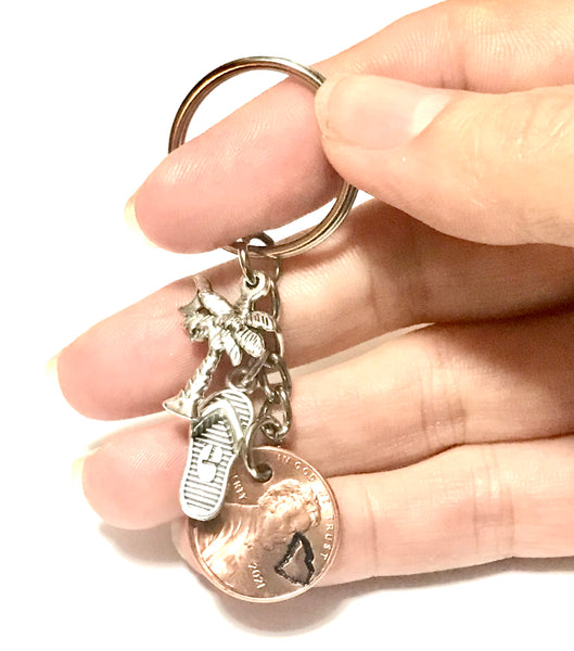 South Carolina Palmetto Tree with Crescent Moon Charm with a Silver Flip Flop Charm together with a Lincoln Cent engraved with the State outline above the date of a Lincoln Cent to make a Lucky Penny Keychain.