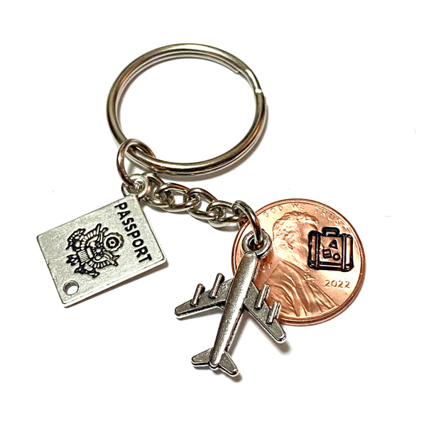 This gift for travelers is a Lucky Penny Keychain. It comes with a silver passport charm and silver airplane charm. We hand stamp your penny with a suitcase stamp or plane stamp.