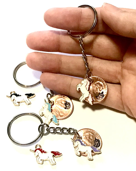A Unicorn Lucky Penny Keychain with Charm and hand stamped design above the date of a Lincoln Cent. Choose from Black, Blue, Pink, Purple, or Red.
