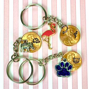 Elephant, Flamingo, Dog Paw, and more animal lucky penny keychain charms.