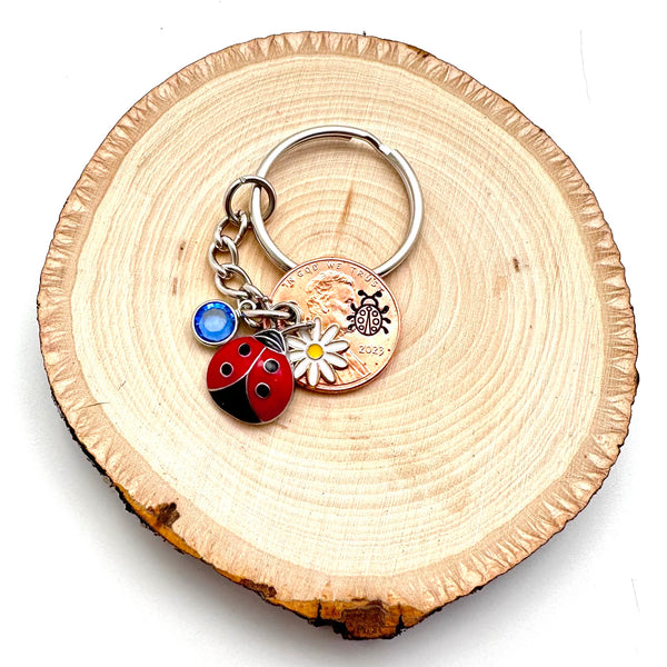 Lucky ladybug keychain with charms, birthstone, and stamped penny.