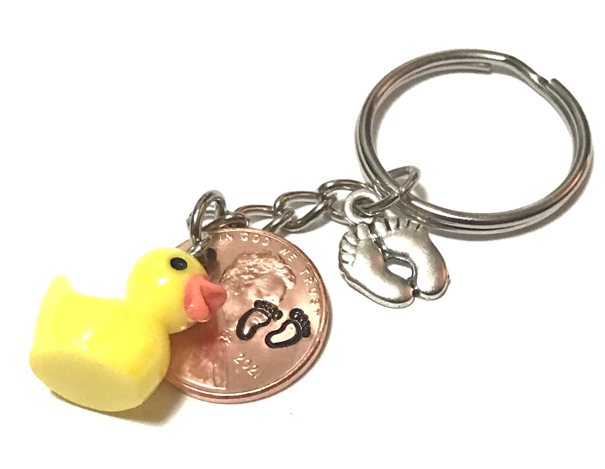 Silver Baby Feet and Yellow Duck Charms on a Lucky Penny Keychain with hand stamp engraved Baby Feet design on a Lincoln Cent.