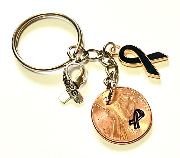 Skin Cancer Awareness Black Ribbon Charm with a silver HOPE charm with an engraved ribbon design on a Lincoln Cent to make a great Lucky Penny Keychain.