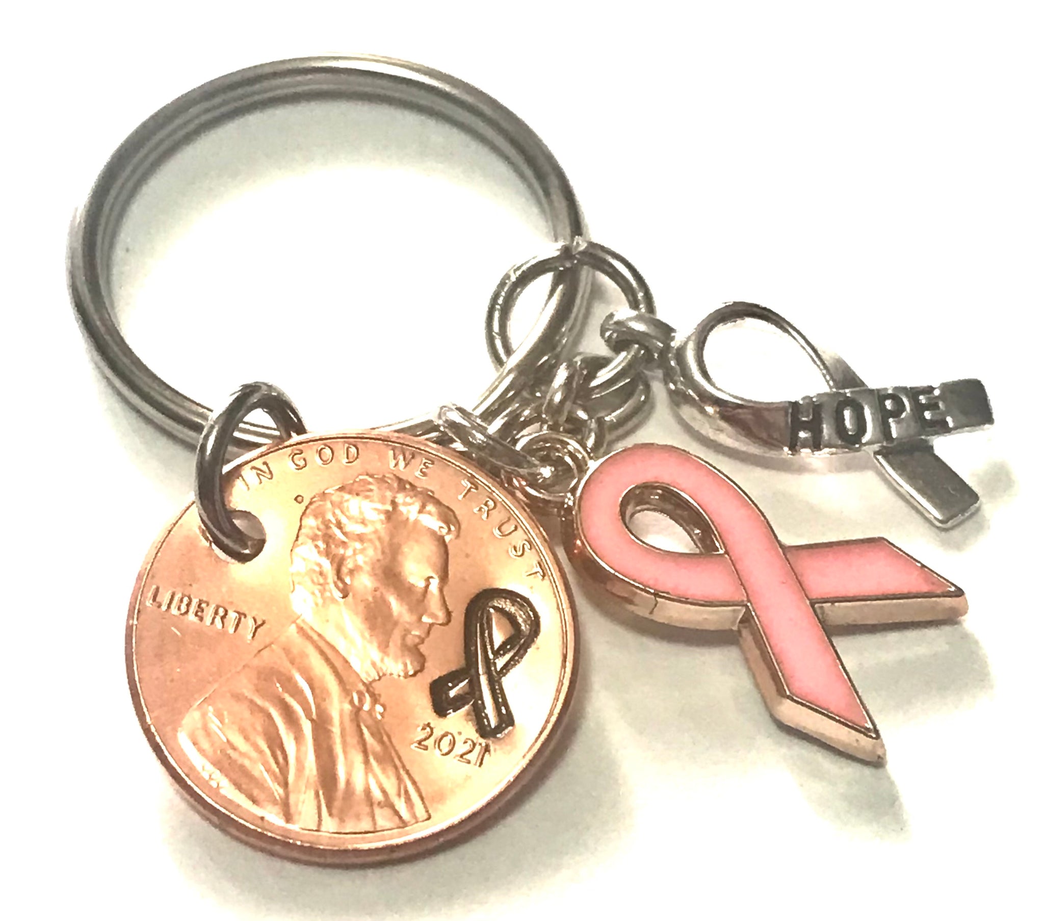 Pink Ribbon and Silver Hope Charm on a Lucky Penny Keychain engraved with a ribbon design in honor of Breast Cancer Awareness.
