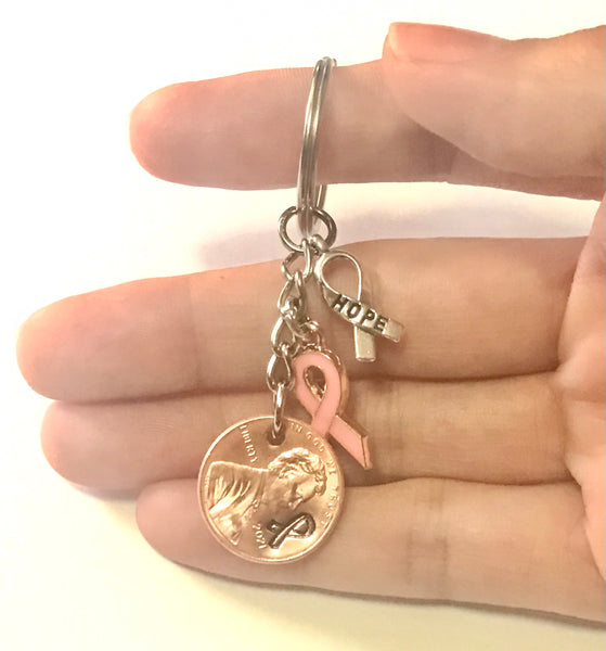 Pink Ribbon and Silver Hope Charm on a Lucky Penny Keychain engraved with a ribbon design in honor of Breast Cancer Awareness.