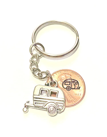 A silver bumper pull trailer charm for camping enthusiasts that travel the country who enjoy an RV lifestyle. 