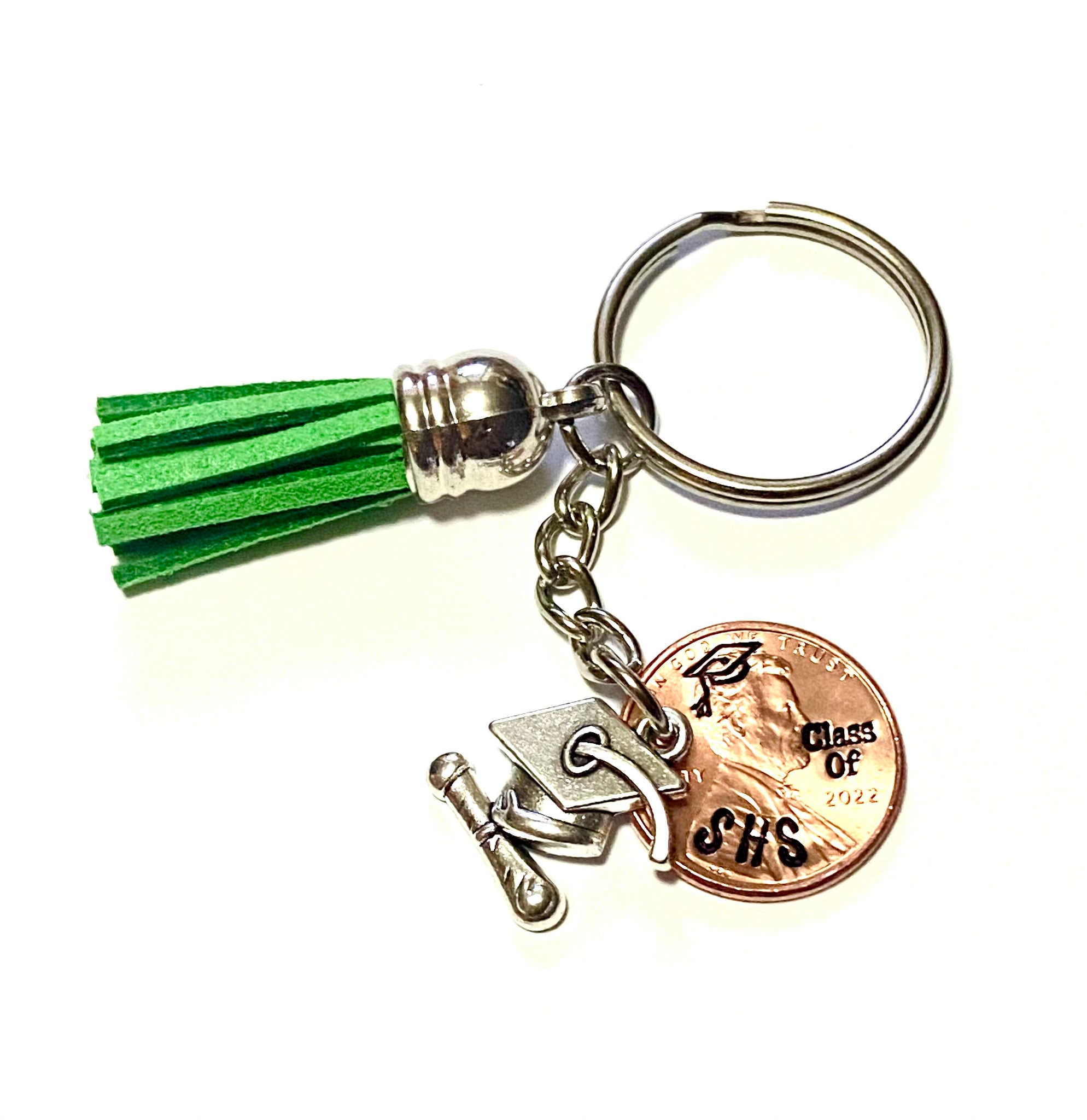 Class of 2022 Graduation Gift Lucky Penny Keychain with a green tassel attached. The penny is engraved with a grad cap, class of, and high school initials. 
