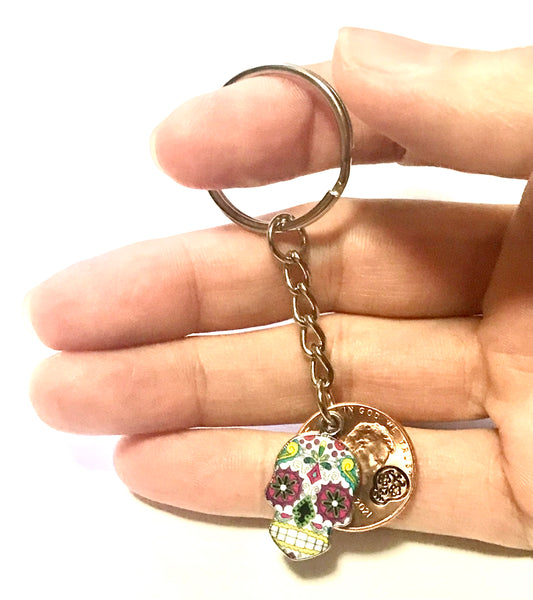 Colored Sugar Skull Lucky Penny Keychain with an engraved design above the date of a Lincoln Cent. Makes a great gift for Día de los Muertos!