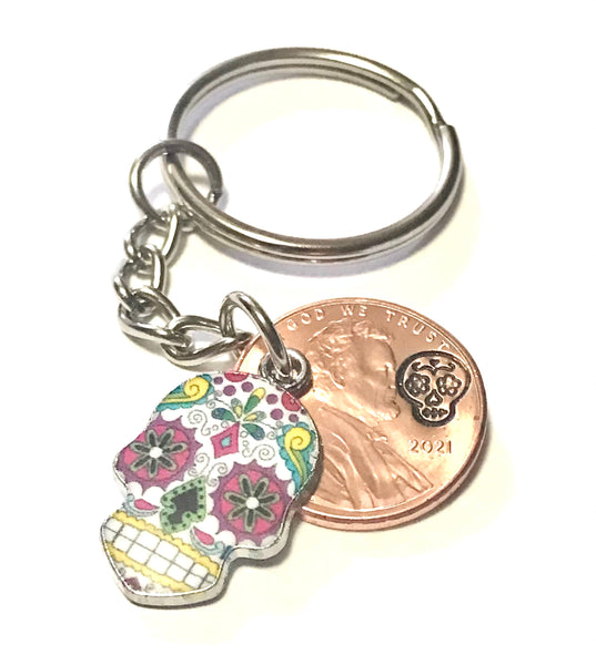 Colored Sugar Skull Lucky Penny Keychain with an engraved design above the date of a Lincoln Cent. Makes a great gift for Día de los Muertos!