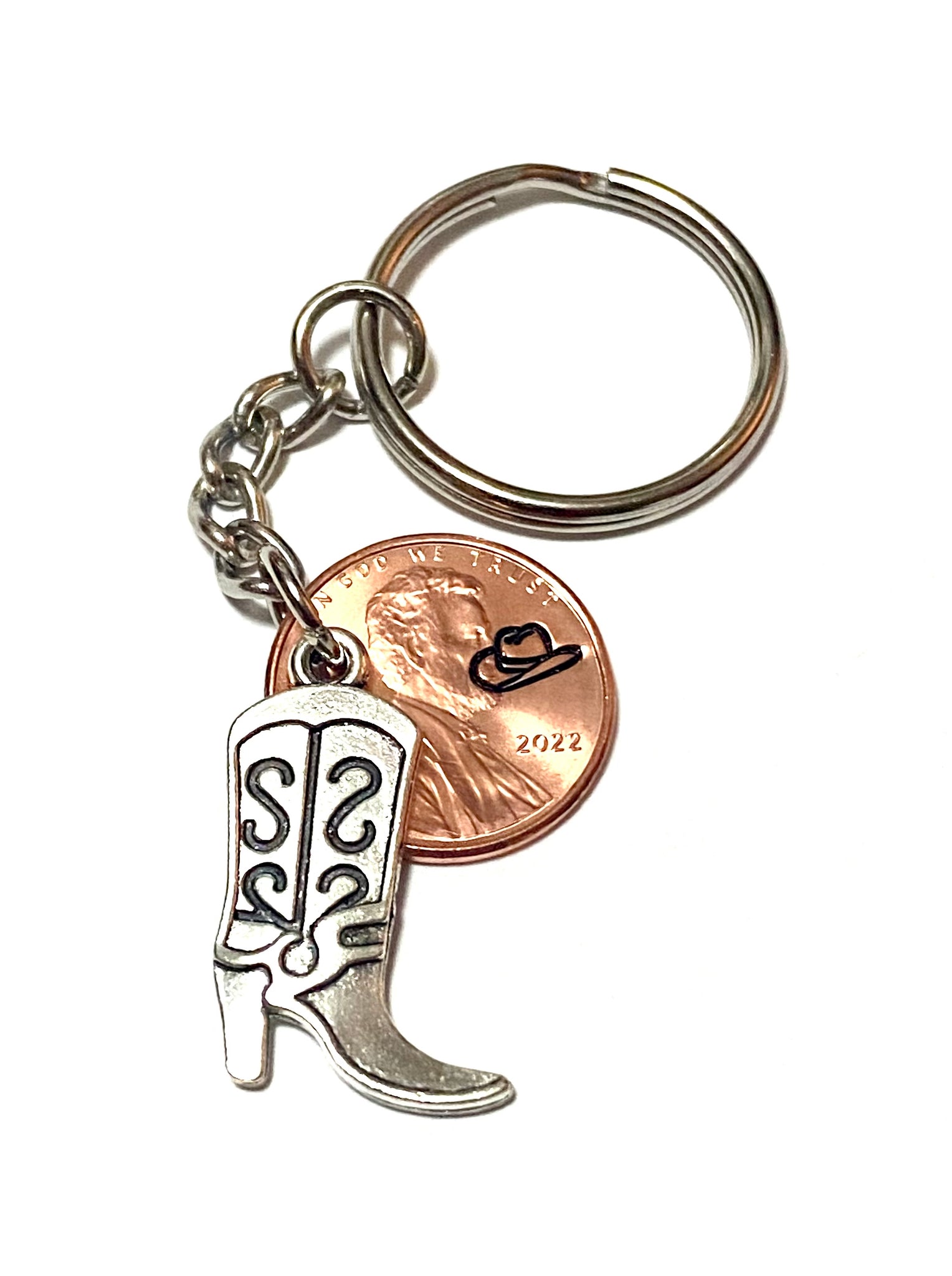 A Silver Cowgirl Boot charm attached to a Lincoln Cent with a cowgirl hat engraved above the date on this 3" Lucky Penny Keychain.