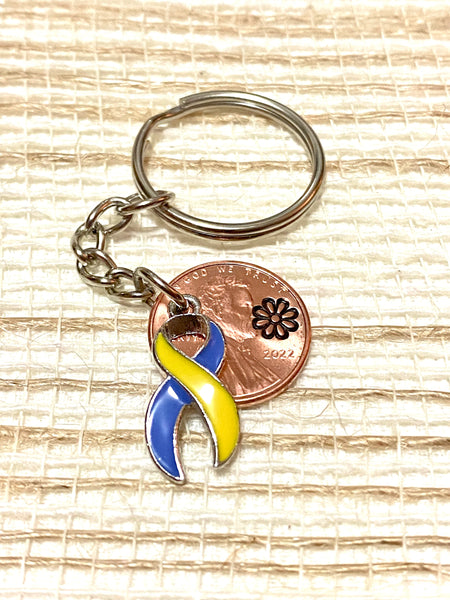 The Down Syndrome Awareness Ribbon on a Lucky Penny Keychain with a Lincoln Cent engraved with a daisy flower design above the date. This charm is a great gift on this Lucky Penny Keychain.