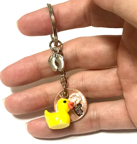 Silver Baby Feet and Yellow Duck Charms on a Lucky Penny Keychain with hand stamp engraved Rocking Horse design on a Lincoln Cent.