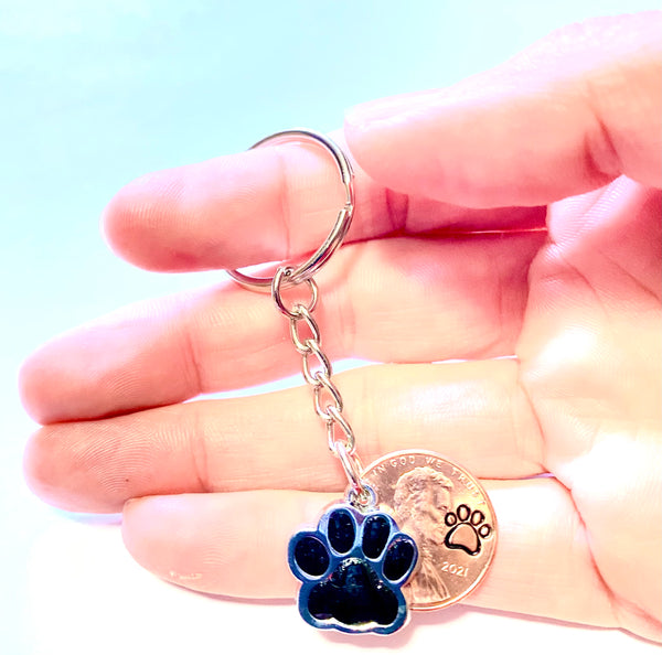 Black Dog Paw Print Charm Lucky Penny Keychain with an engraved dog paw design above the date of a Lincoln Cent.