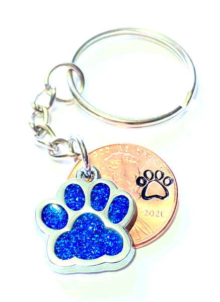 Blue Dog Paw Print Charm Lucky Penny Keychain with an engraved dog paw design above the date of a Lincoln Cent.