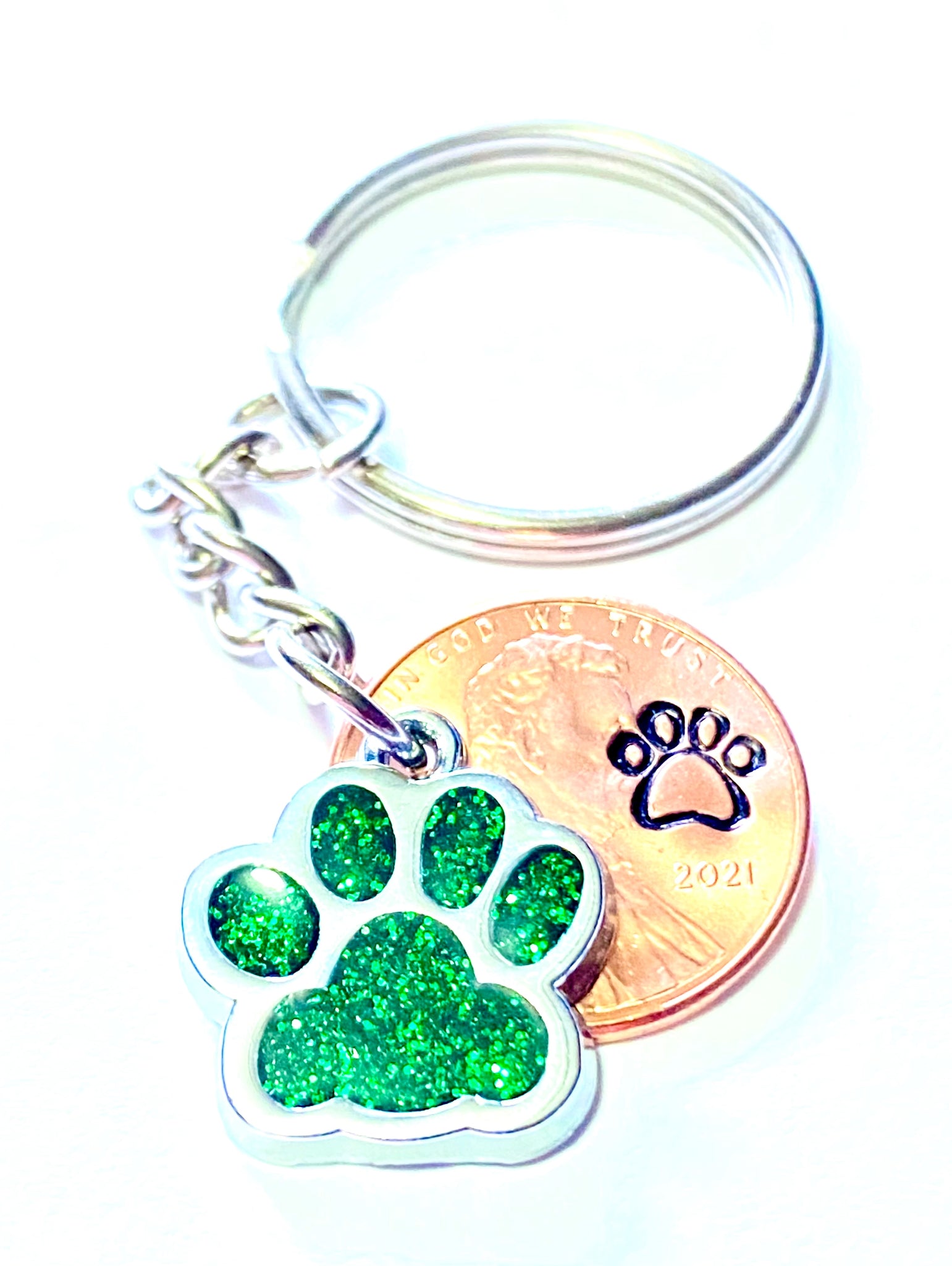 Green Dog Paw Print Charm Lucky Penny Keychain with an engraved dog paw design above the date of a Lincoln Cent.