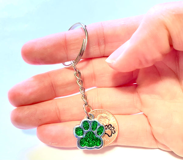 Green Dog Paw Print Charm Lucky Penny Keychain with an engraved dog paw design above the date of a Lincoln Cent.