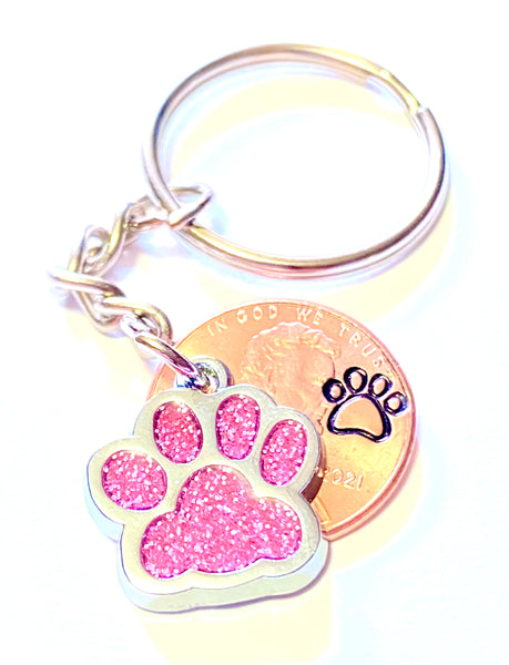 Pink Glitter Dog Paw Print Charm Lucky Penny Keychain with an engraved paw print design above the date of a Lincoln Cent.