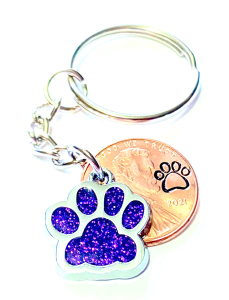 Purple Glitter Dog Paw Print Charm Lucky Penny Keychain with an engraved paw print design above the date of a Lincoln Cent.