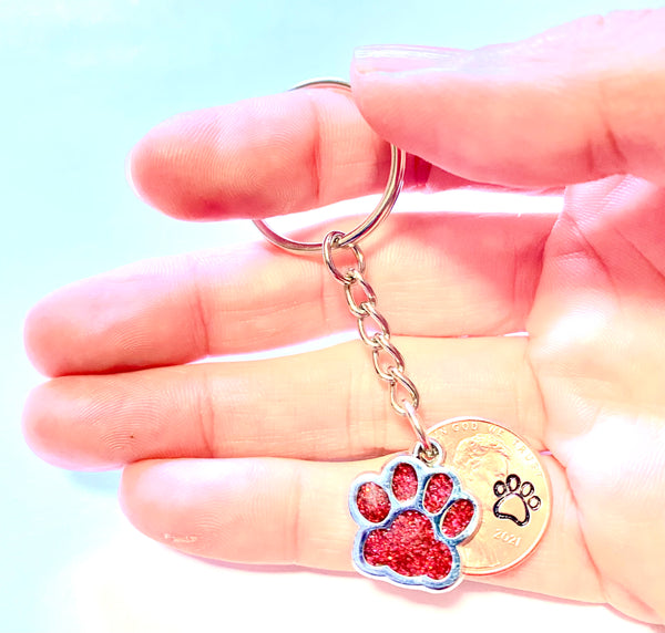 Red Dog Paw Print Charm Lucky Penny Keychain with an engraved dog paw design above the date of a Lincoln Cent.