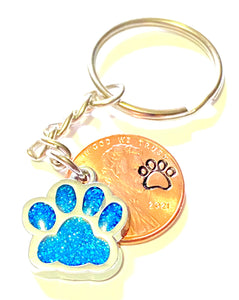 Light Blue Dog Paw Print Charm Lucky Penny Keychain with an engraved dog paw design above the date of a Lincoln Cent.