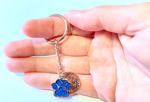 Light Blue Dog Paw Print Charm Lucky Penny Keychain with an engraved dog paw design above the date of a Lincoln Cent.