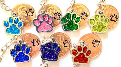 Colorful Glitter Dog Paw Print Charm Lucky Penny Keychains with an engraved paw print above the date of a Lincoln Cent.