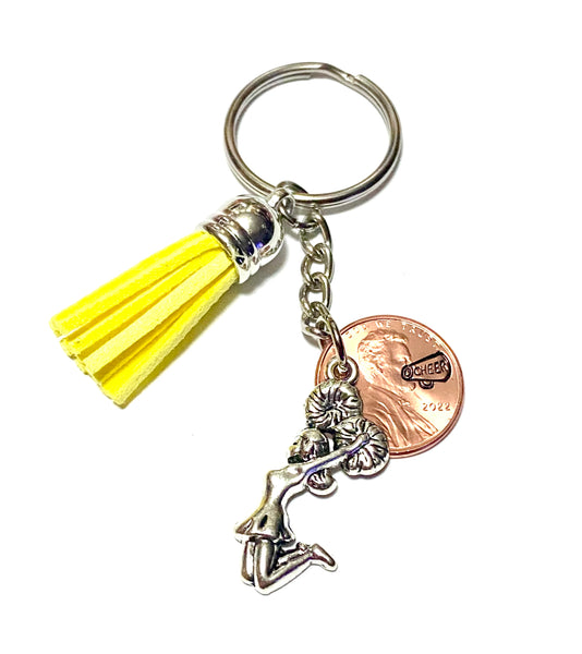 This yellow tassel is attached to our popular cheerleader charm and penny with a megaphone engraved above the date.