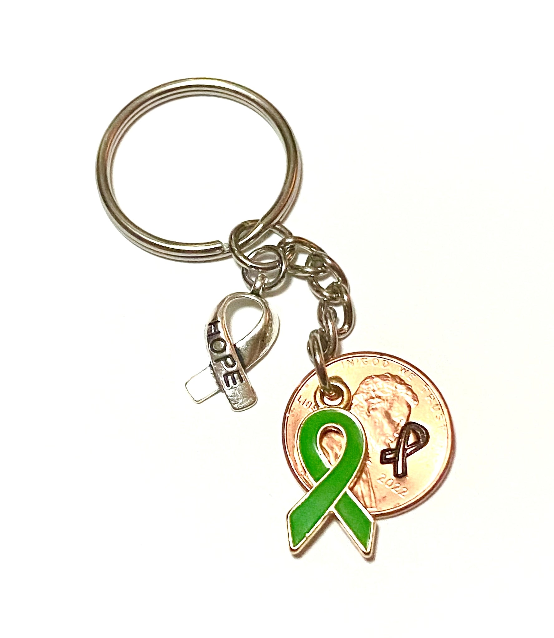 A green ribbon charm for mental health awareness month with a silver HOPE charm attached to a Lincoln Cent engraved with a detailed design of an awareness ribbon for a great Lucky Penny Keychain!