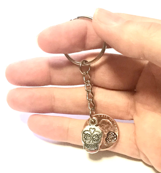 Silver Sugar Skull Lucky Penny Keychain with an engraved design above the date of a Lincoln Cent. Makes a great gift for Día de los Muertos!