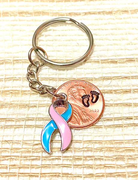 A SIDS Awareness Charm and a Lincoln Cent hand stamped with footprints attached to a 3" keychain so you can find the right key fast!