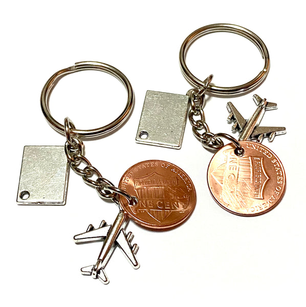 This gift for travelers is a Lucky Penny Keychain. It comes with a silver passport charm and silver airplane charm. We hand stamp your penny with a suitcase stamp or plane stamp.